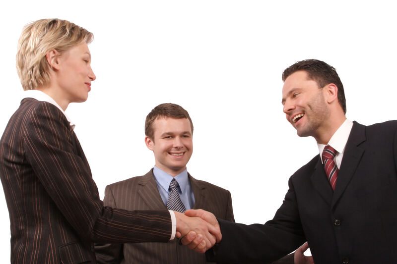 Two professionals meeting across a table for one-on-one mentorship
